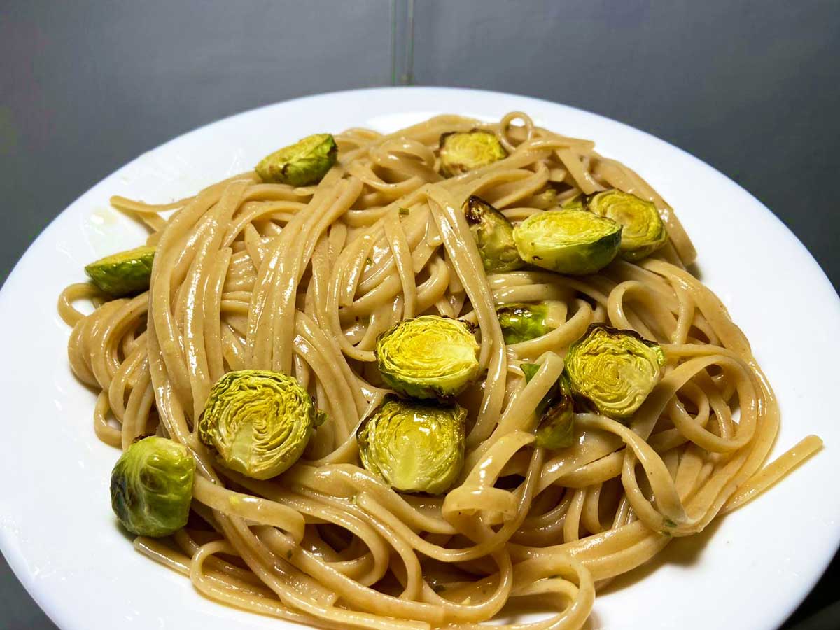 Piatto di pasta con cavoletti di Bruxelles, limone e rosmarino visto da tre quarti
