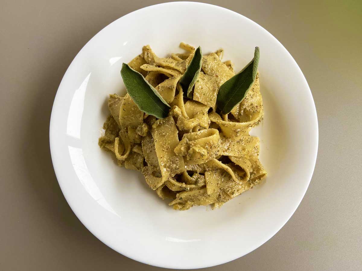 Piatto di pasta con pesto di salvia e mele visto dall'alto